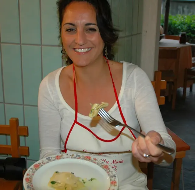 A student tasting the dish she prepared